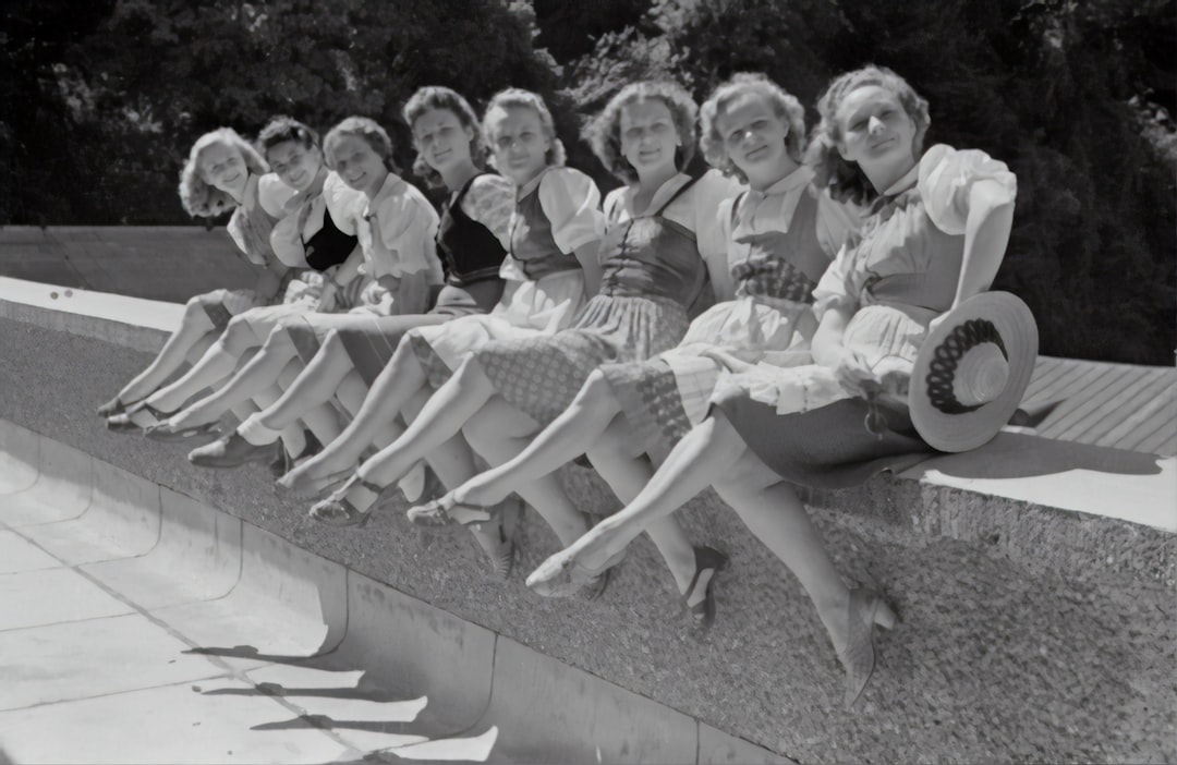 Salzburg Festival 1946 by Makeup Brands grayscale photo of group of women sitting on concrete bench