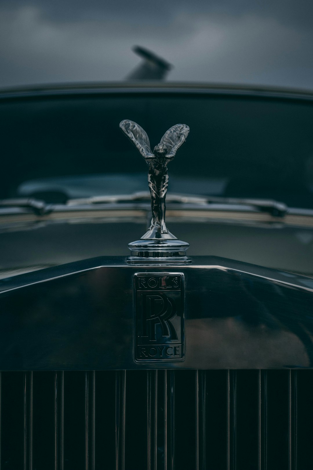 👑 The Allure of Opulence: A Deep Dive into Luxury Makeup's Rich History and Enduring Appeal by Makeup Brands the emblem on the front of a vintage car