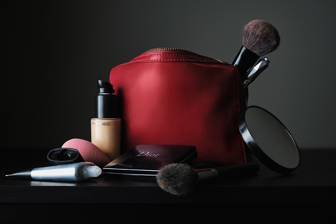 Brush study. by Makeup Brands red leather bag beside black makeup brush