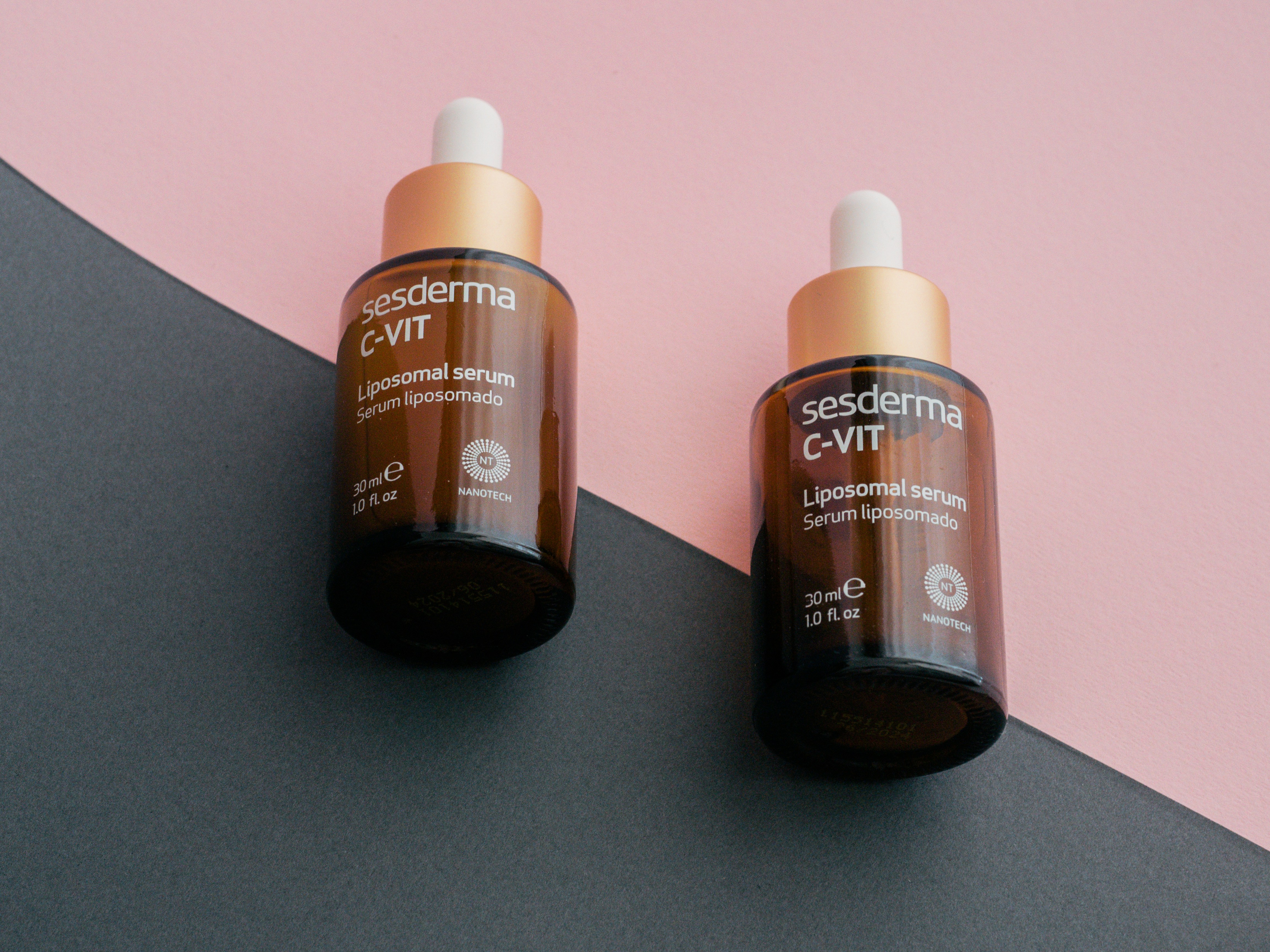 Conclusion: The Final Verdict on Drugstore vs High-End Skincare by Makeup Brands two bottles of gerania vitamin c - lift on a pink and black background