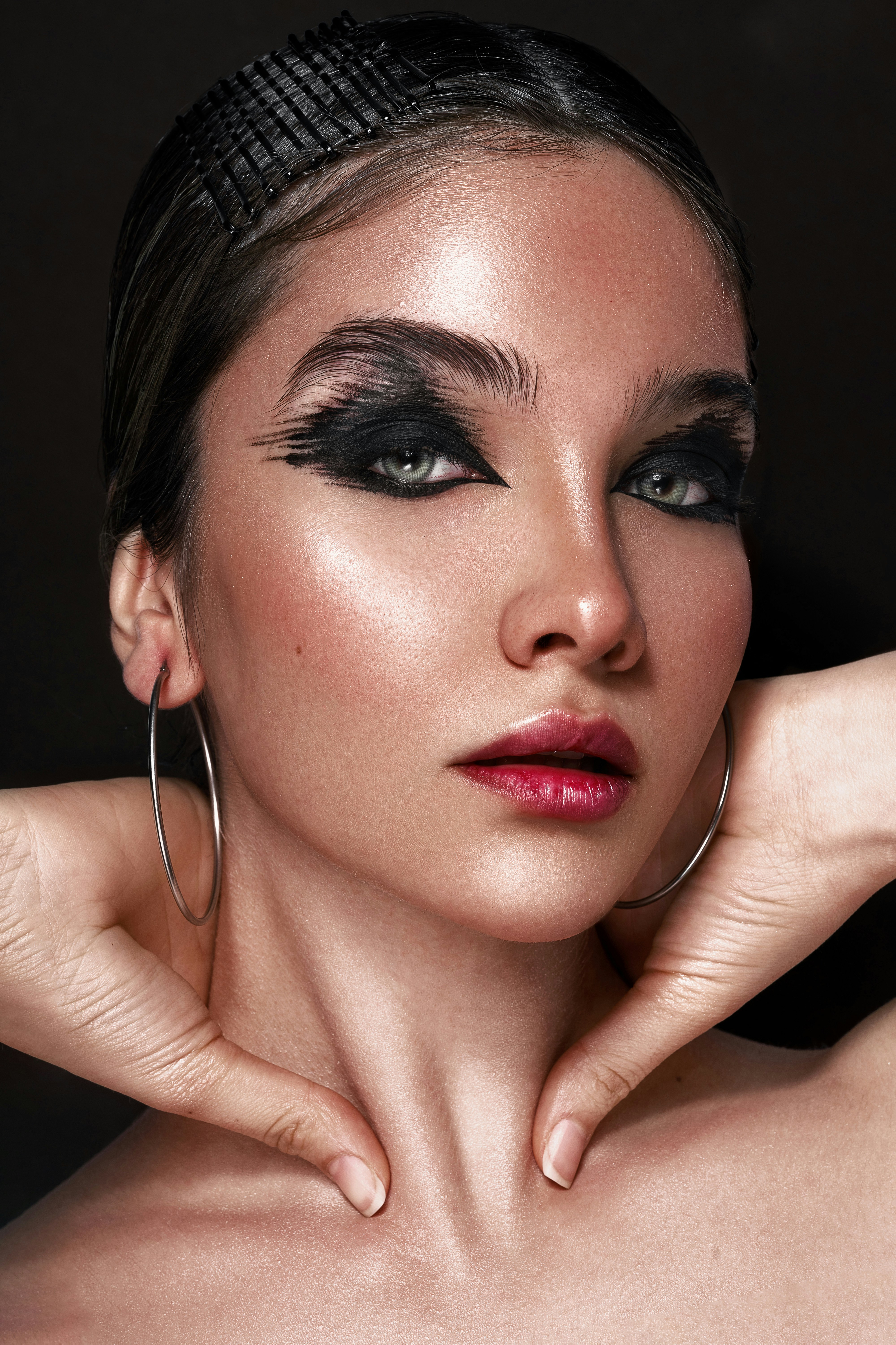 a woman with large hoop earrings on her neck